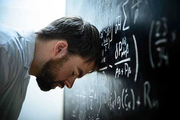 A scientist in front of a blackboard filled with formulas and equations